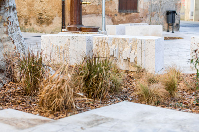 carved travertine transforms paving, furniture, and planting across spanish historic old town - 4