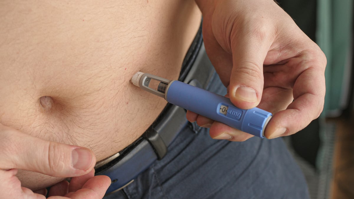 A person using an injection pen.