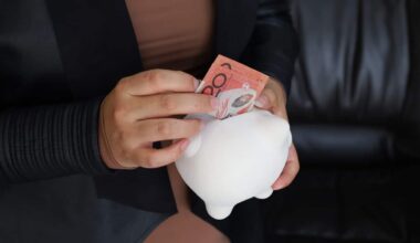 Someone putting money into a piggybank.
