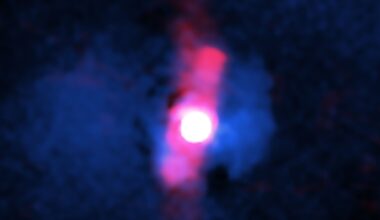A blurry pinkish red circle surrounded by two jets of pink light.