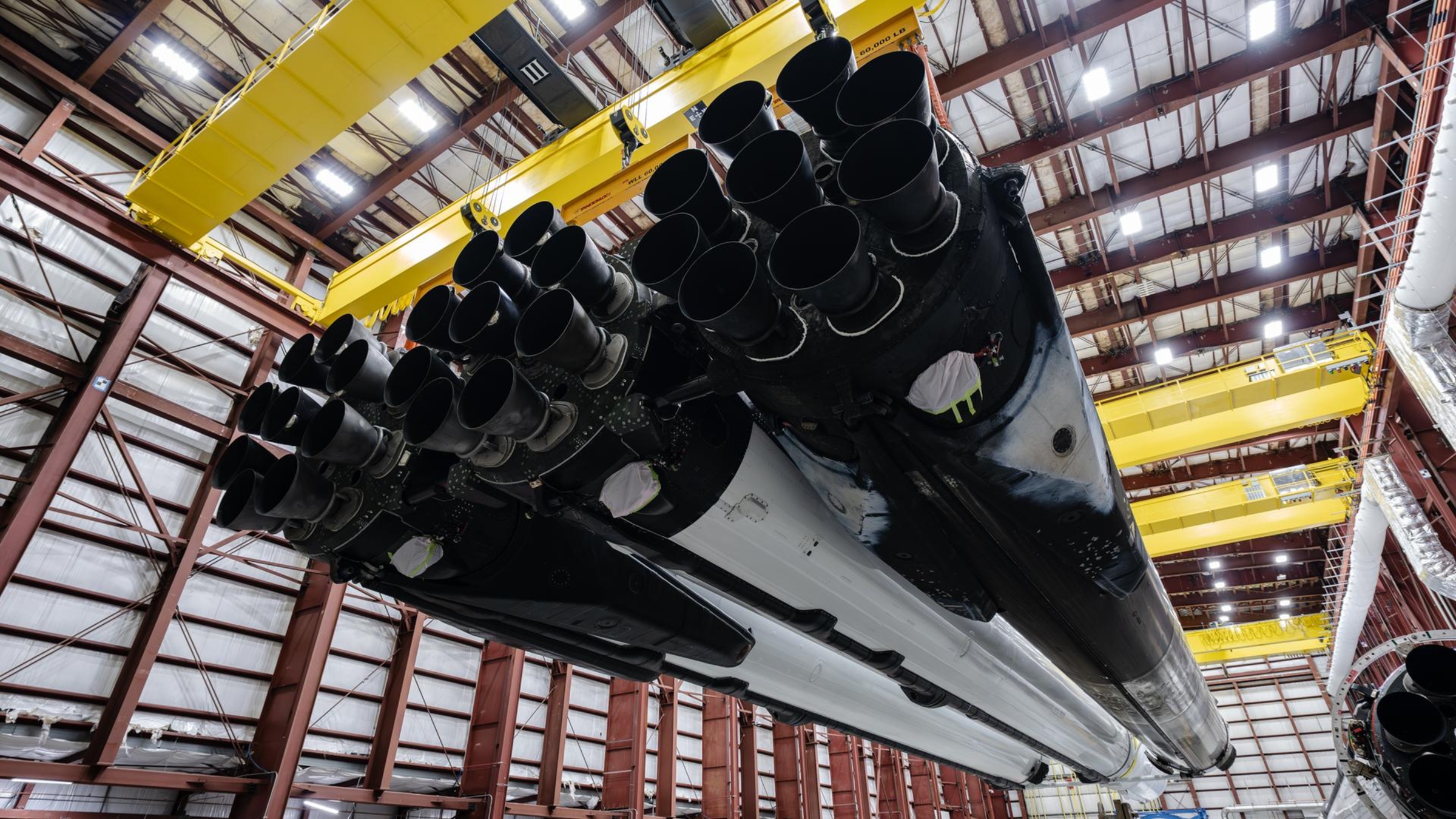 A photo of the Falcon Heavy rocket boosters hanging in a warehouse