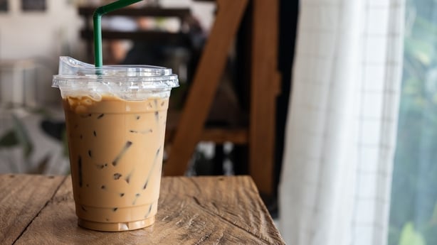 Plastic cup with an iced coffee and a straw