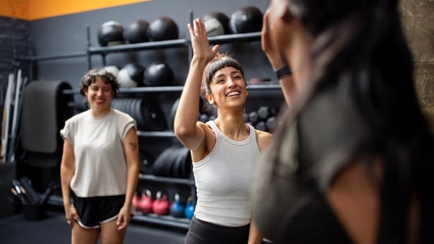 group of gym friends celebrating successful workout