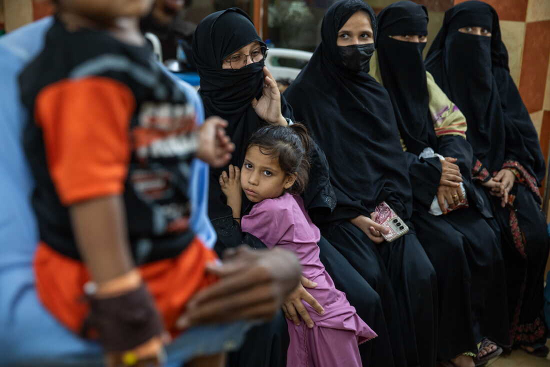 Parents and children wait for care at Kulsum Bai Valika Hospital on July 25, 2026 in Karachi, Pakistan. Families say their children tested positive for HIV after syringes were used on multiple children seeking treatment for other illnesses.