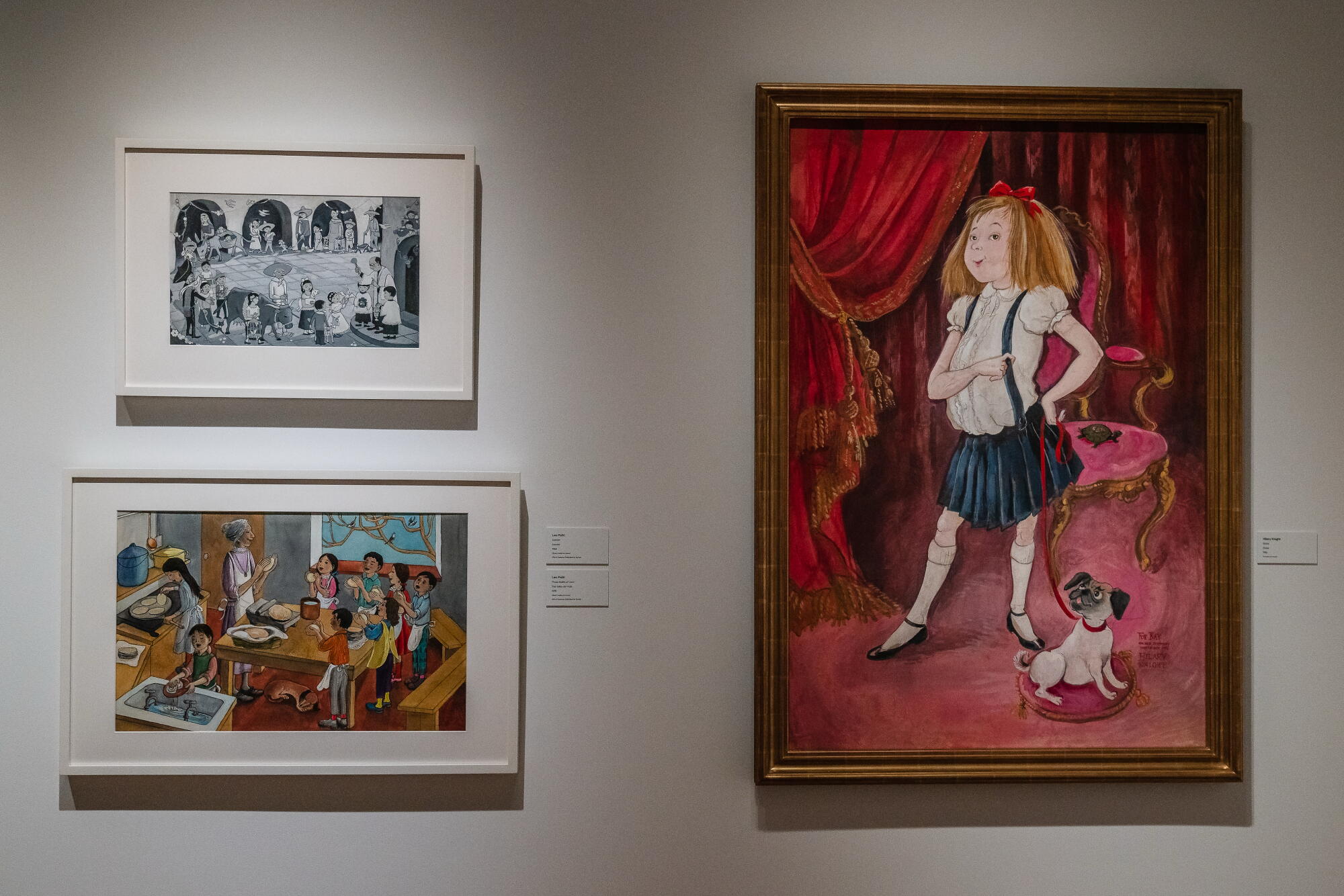 Children's book illustrations and artwork in a museum.