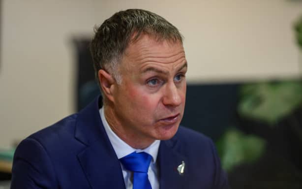 Minister of Local Government, Simon Watts speaking to media at Parliament during an announcement about rates caps.