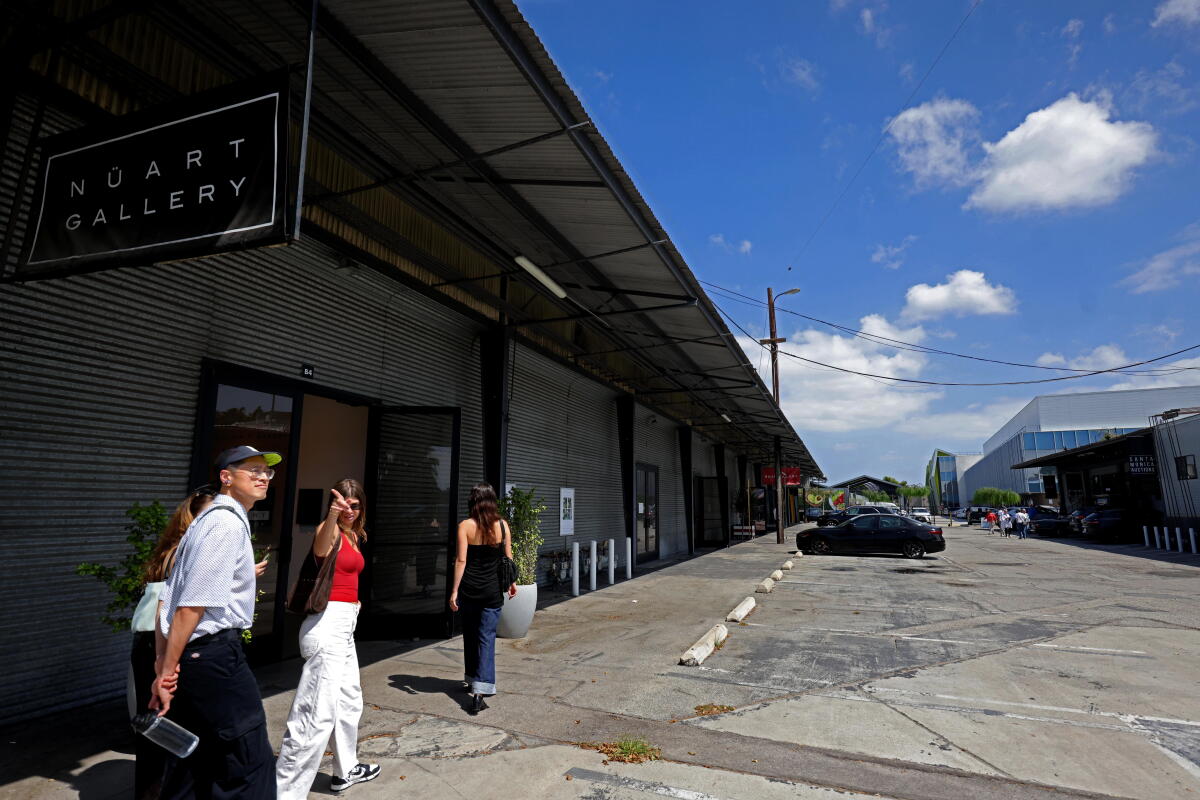 Art patrons walk past a row of galleries at Bergamot Station.