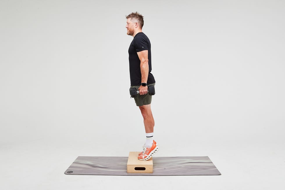 Person performing an exercise on a platform with dumbbells.