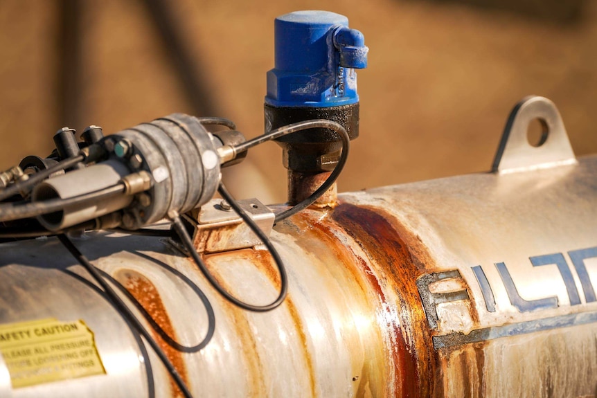 Water drips from bore infrastructure which is discoloured from its contents.