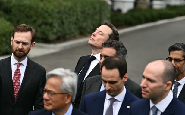 SpaceX CEO Elon Musk looks up as US President Donald Trump speaks to the press after a meeting with technology executives about artificial intelligence at the White House in Washington, DC, on September 29, 2026. The gathering comes quickly after tech giant OpenAI's cancellation of the release of its newest model due to safety concerns, and a series of revelations that the technology had gone rogue. (Photo by Kent NISHIMURA / AFP)