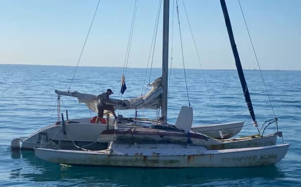 Digby Campbell had been standing at the Singapore Sling's helm for a day and a half when he was finally rescued. (Supplied: Joshua Witkin)