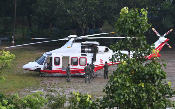 Nepali soldiers prepare a helicopter for morning rescue sorties at Trishuli in Nepal's Nuwakot district on August 30, 2026, after flash floods and landslides hit the Nepal-Tibet border. The number of people missing in the catastrophic flood that sliced through the border area between Nepal and Tibet neared 3,000 on August 30, as rescuers scoured deep, leg-sucking mud for survivors. (Photo by Arun SANKAR / AFP)