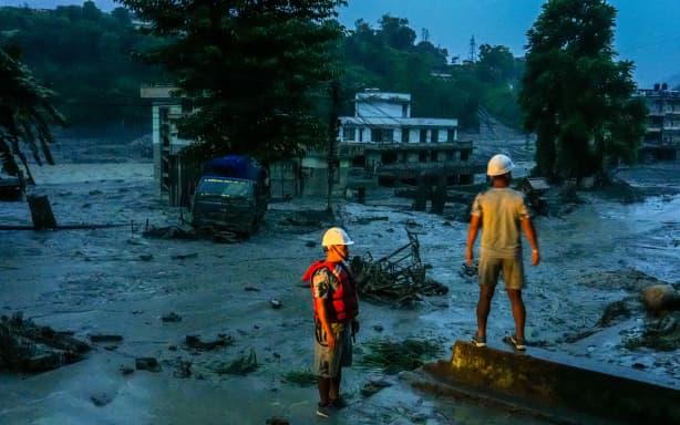 Rescue teams observe flood-damaged areas after a flash flood swept through the Bhotekoshi River area in Nuwakot, Nepal, on August 26, 2026. The flooding caused widespread damage to homes, roads, bridges and other infrastructure in the area, while many people remain missing; the figures are still developing (Photo by Ambir Tolang/NurPhoto) (Photo by Ambir Tolang / NurPhoto via AFP)