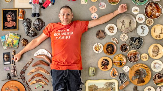 Tony Albert with examples of kitsch Aboriginalia sent in by the public – some of it is funny, others are horrific.
