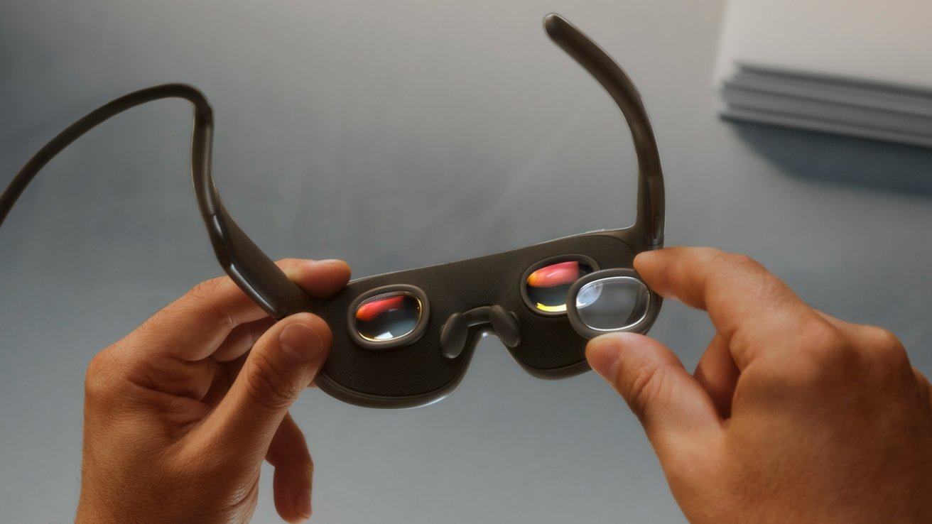 Hands holding Meta VR Glasses, showing curved dark frame and reflective lenses with small colorful displays, on a smooth gray tabletop with a blurred stack of papers in the background