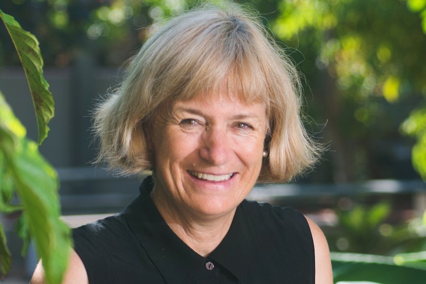 A smiling, middle-aged woman with blonde hair.