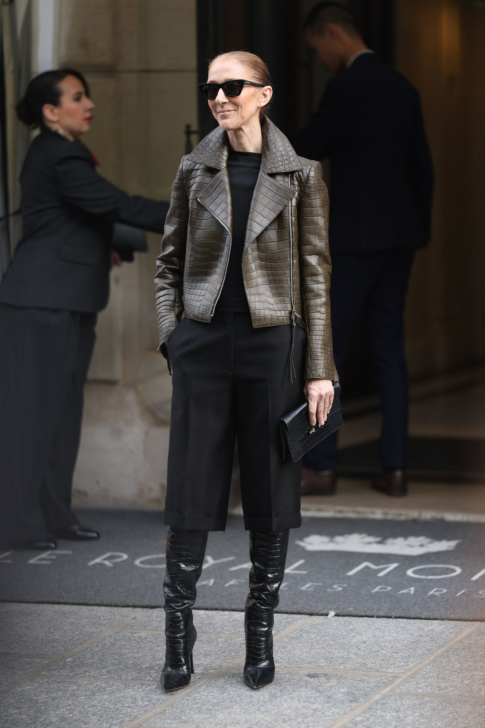 Image may contain Cline Dion Clothing Coat Jacket Formal Wear Suit Adult Person Accessories Bag and Handbag