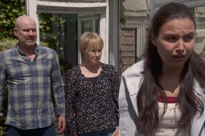 Joe Duttine as Tim Metcalfe, Sally Dynevor as Sally Metcalfe and Anya Dewin as Lucy Parkinson in Coronation Street. Joe Duttine as Tim Metcalfe and Sally Dynevor as Sally Metcalfe standing behind Anya Dewin as Lucy Parkinson in a garden, with the latter shouting.
