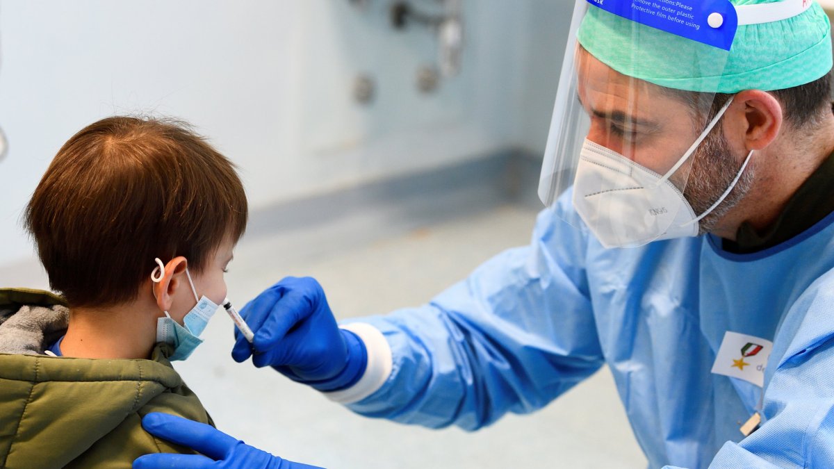 A military doctor administers a flu vaccine to a child in a military hospital after health authorities advised people to take a flu vaccine to avoid confusion with the coronavirus disease (COVID-19) symptoms, in Milan, Italy, November 20, 2020. REUTERS/Flavio Lo Scalzo