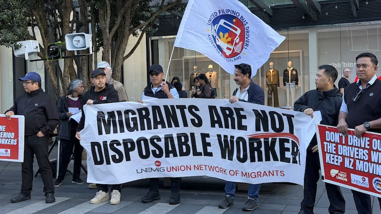 A banner reading 'migrants are not disposable workers' at a rally in the Auckland CBD.