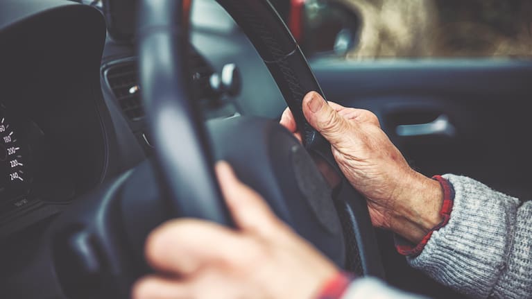 A man behind the wheel of a car.