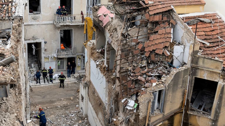 A rescuer works at the scene following Friday's powerful blast in Athens' Plaka district. 