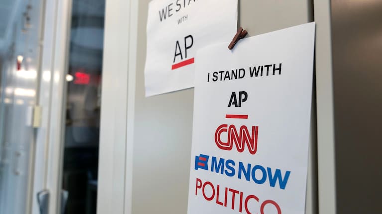 A sign in support of news outlets is seen at the White House press room. 