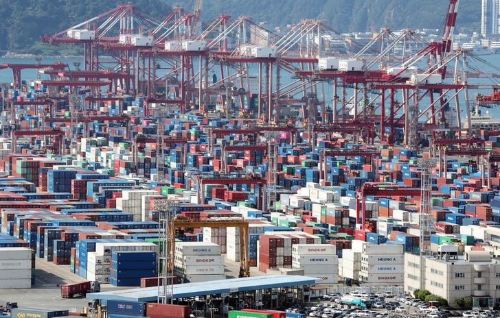 Containers bound for export are stacked at a port in Busan, Aug. 6. Yonhap