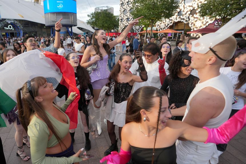 Fans of Ariana Grande sing as they arrive at her concert at the O2 Arena in London on Tuesday.