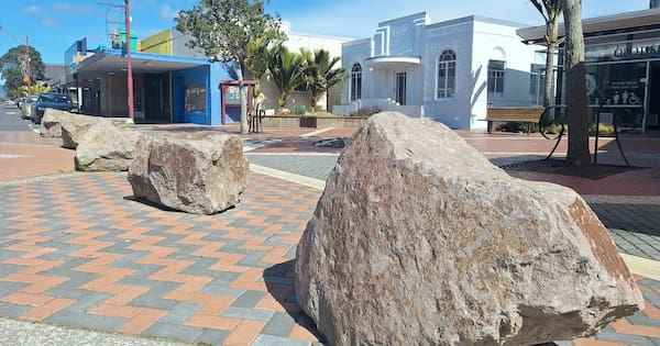 Boulders block carparks – so drivers park on footpaths