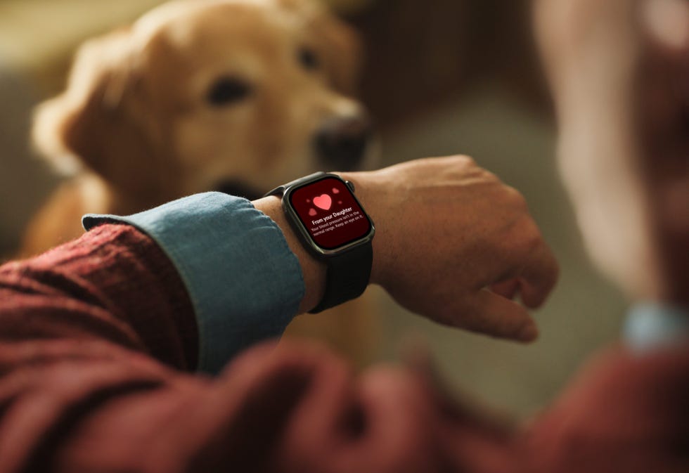 smartwatch displaying heartwarming message with dog in background.
