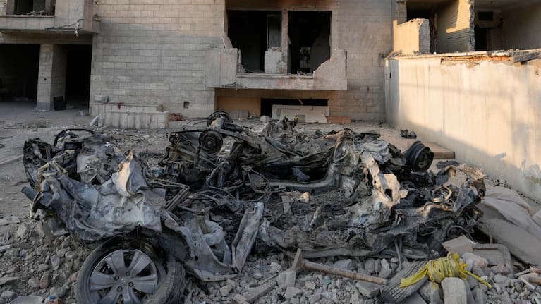 Cars and residential buildings damaged in a U.S.-Israeli strike on March 8 remain in ruins in Tehran, Iran, Thursday, Aug. 27, 2026.