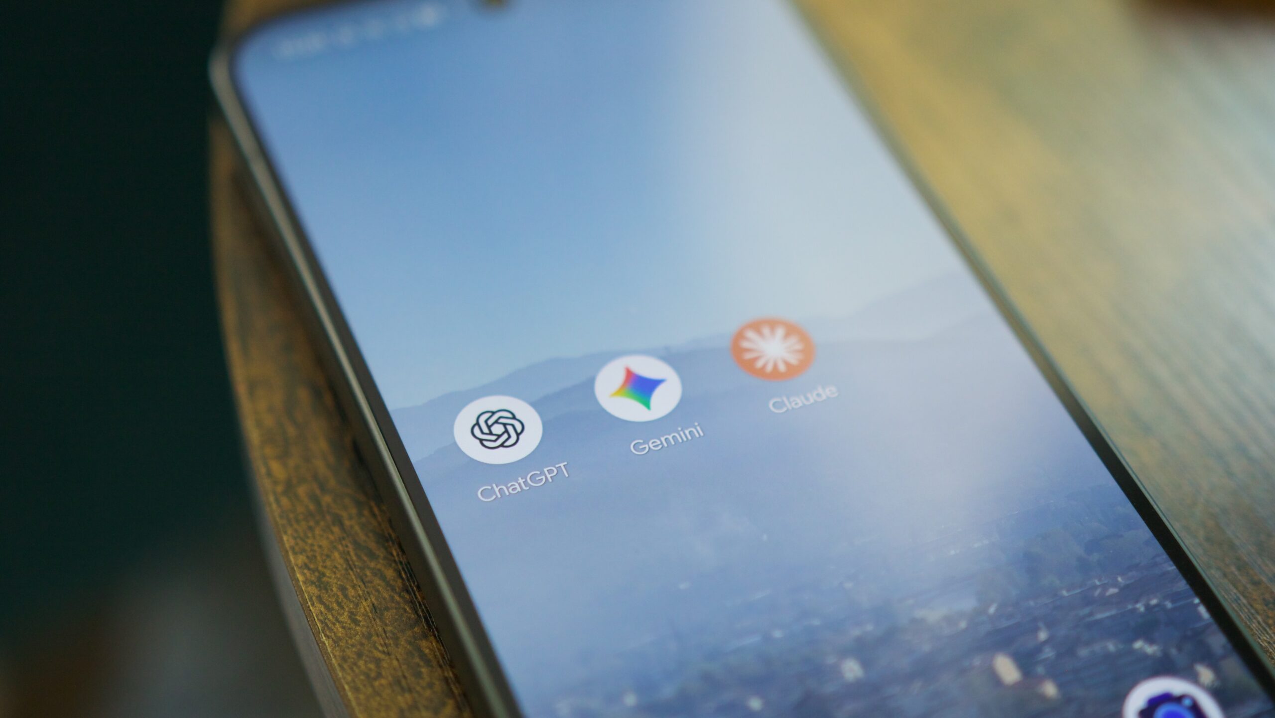 ChatGPT, Gemini, and Claude app icons on a Pixel phone.