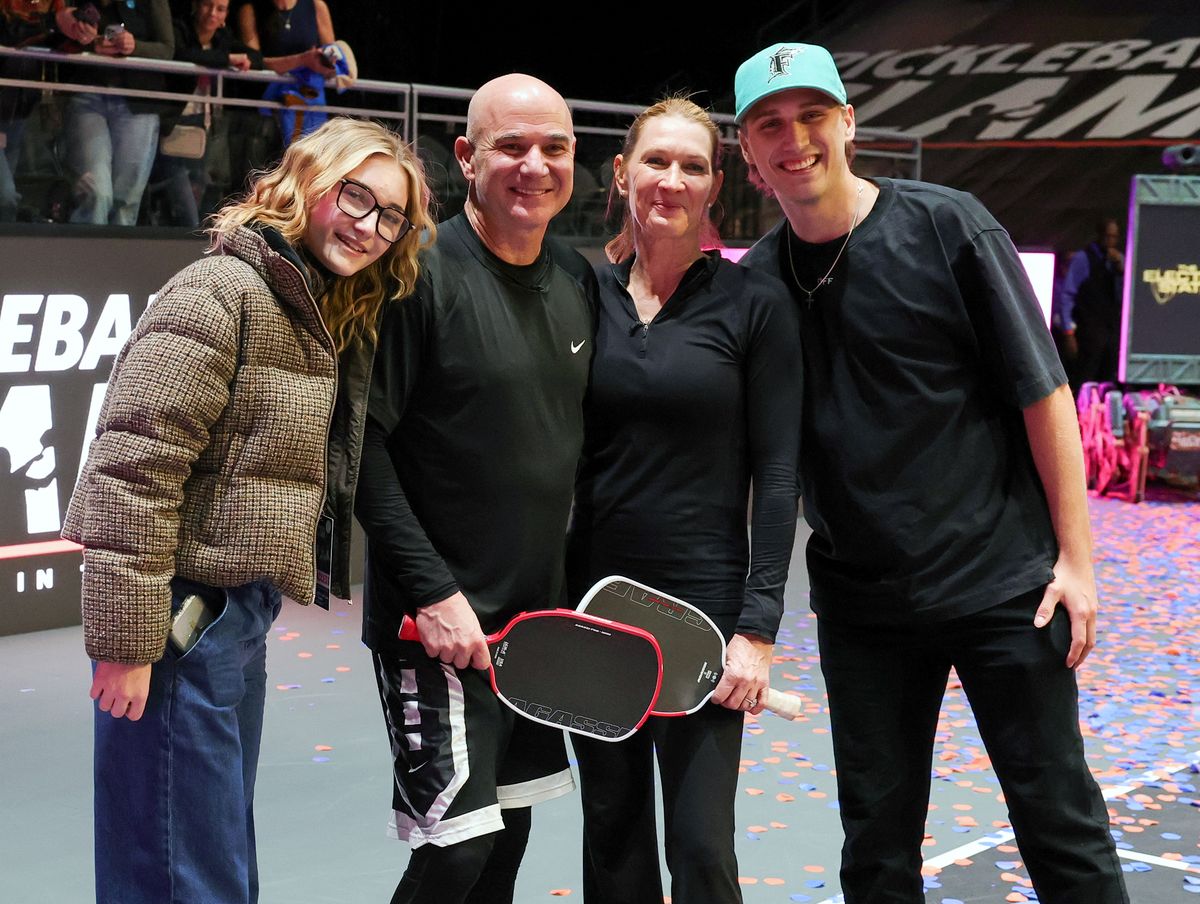 (L-R) Jaz Agassi, Andre Agassi, Steffi Graf and Jaden Agassi pose on the court after Andre Agassi and Graf.