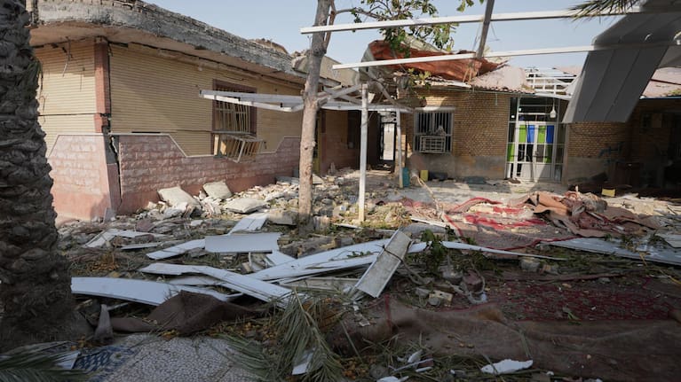 Debris is scattered across the courtyard of a building that Iranian media said was hit by a U.S. strike while a wedding celebration was taking place there, in Kuhestak, southern Iran.
