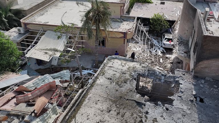 Debris is scattered across the courtyard of a building that Iranian media said was hit by a U.S. strike while a wedding celebration was taking place there, in Kuhestak, southern Iran.
