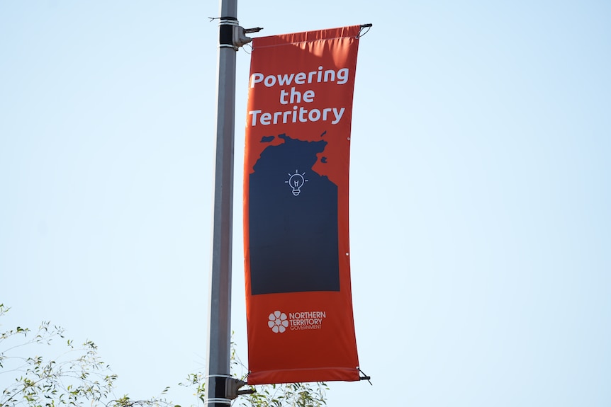 An orange banner on display in the city has a map of the NT alongside the words: Powering the Territory'.