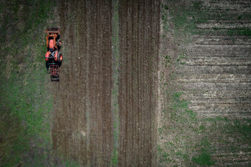 Sue Ferreri, executive director of Rockland Community Farm Network, drives a tractor at a community farm in New York on April 8, 2026. Farm owners face soaring fuel prices.