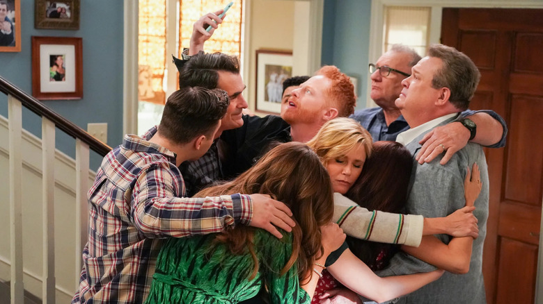 The Pritchett-Dunphy-Tucker-Delgado family hugs and takes a photo in 