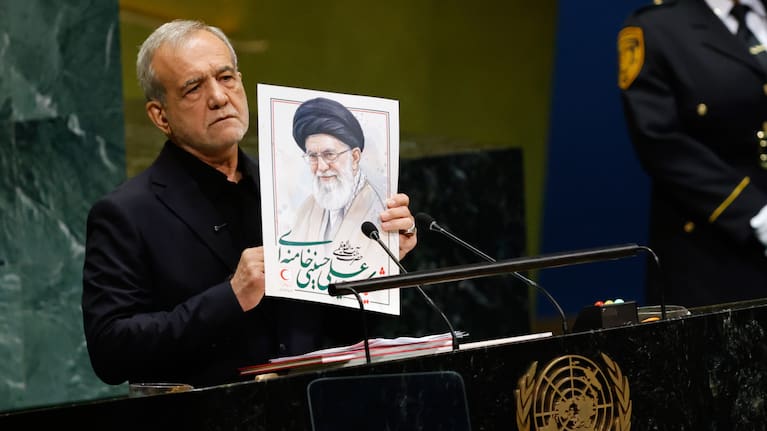Iran's President Masoud Pezeshkian holds an image of late Iranian Supreme Leader Ayatollah Ali Khamenei during the 81st session of the United Nations General Assembly at United Nations headquarters.