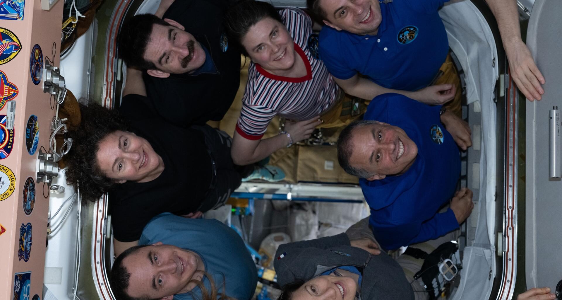 The seven-member Expedition 75 crew poses for a portrait inside the International Space Station. Clockwise from left are, NASA astronauts Jessica Meir and Jack Hathaway, Roscosmos cosmonauts Anna Kikina and Andrey Fedyaev, astronauts Anil Menon of NASA and Sophie Adenot of ESA (European Space Agency), and Roscosmos cosmonaut Pyotr Dubrov.