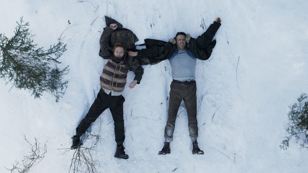 Kenneth Branagh and Ryan Reynolds, Mayday kenneth branagh and ryan reynold lying in the snow with surrounding trees for mayday movie