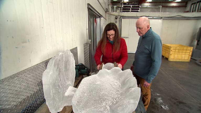 Michelle Taylor working on an ice sculpture as her husband Dennis looks on.
