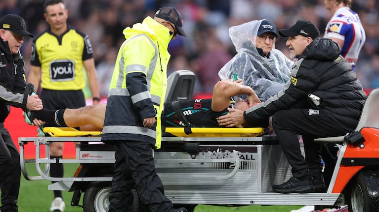 Nathan Cleary of the Panthers is taken from the field on a medicab after injuring his leg.
