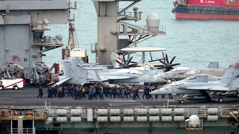 Navy personnel walk on the deck of the US Navy aircraft carrier USS Abraham Lincoln as it arrives at the port in Laem Chabang, Chonburi, Thailand.