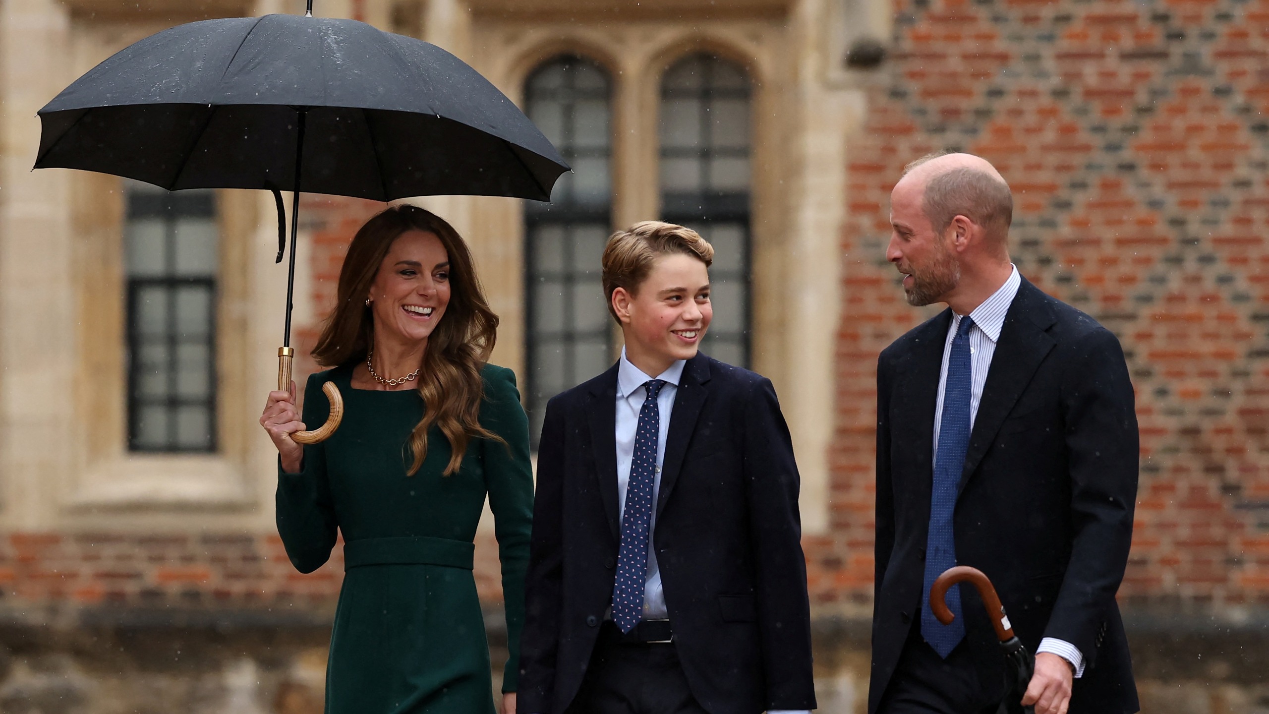 Catherine, Princess of Wales (L) and Prince William (R) walk with their 13-year-old son, Britain's Prince George of Wales (C), as he arrives for his first day at Eton College