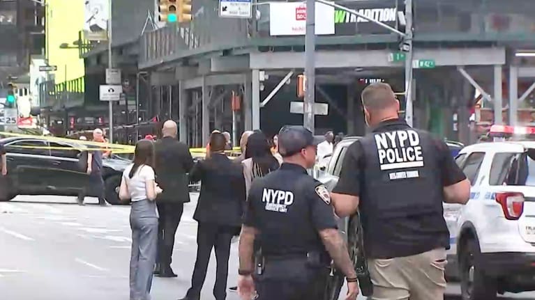 NYPD officers on the scene after a woman brandishing two large knives was shot by officers in Times Square.