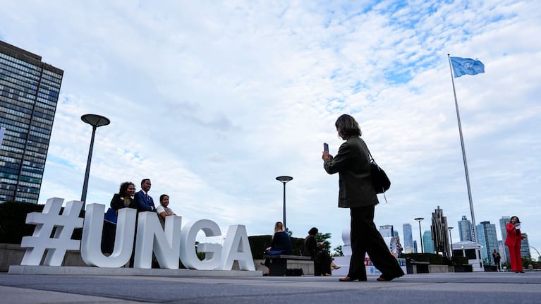 People pose as they arrive for the United Nations General Assembly (UNGA) at the UN headquarters