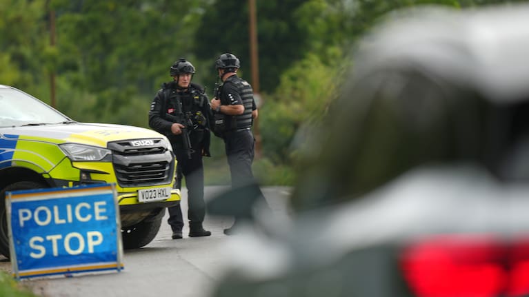 Police guard a road leading to RAF Fairford, a US Airbase, after an incident in Fairford, England.