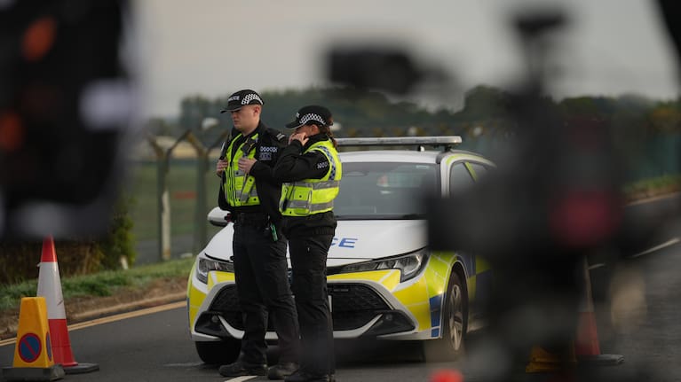 Police officers guard a road leading to RAF Fairford, after an incident in Fairford, England
